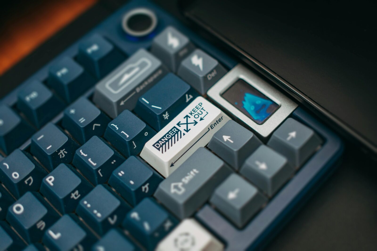 A detailed close-up of a mechanical keyboard featuring customized keycaps with unique designs and colors.